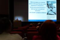 Katherine Satriano at a podium speaking to audience
